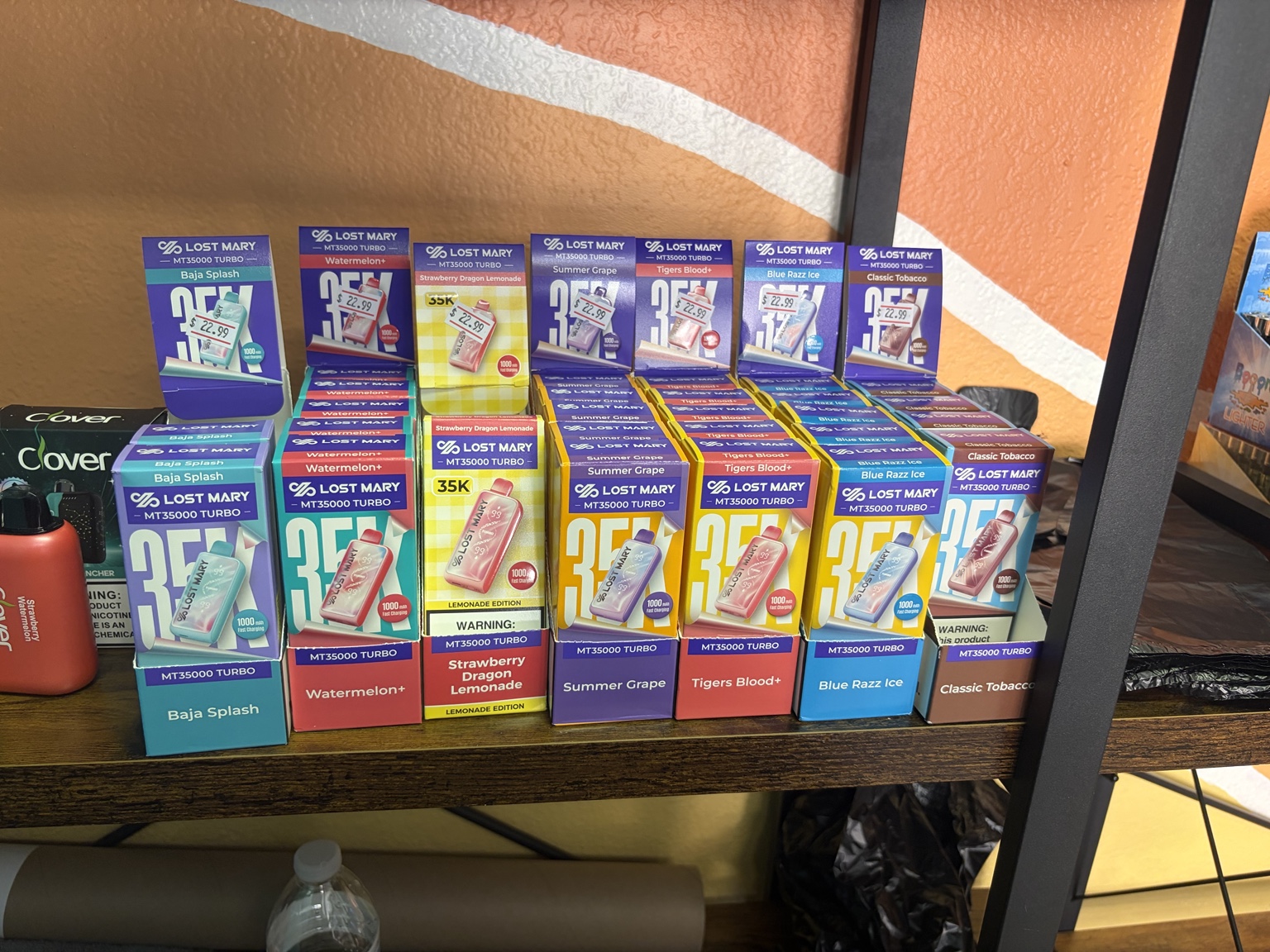 Packaged vape products displayed with nicotine warning labels